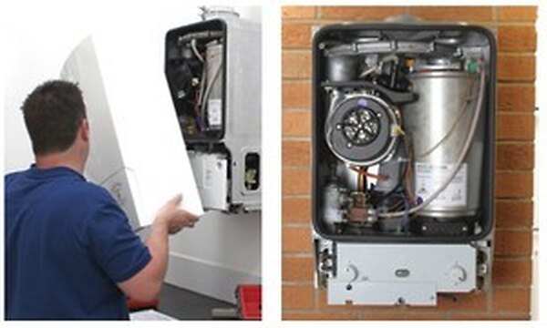 Heating engineer opening a boiler for inspection and servicing